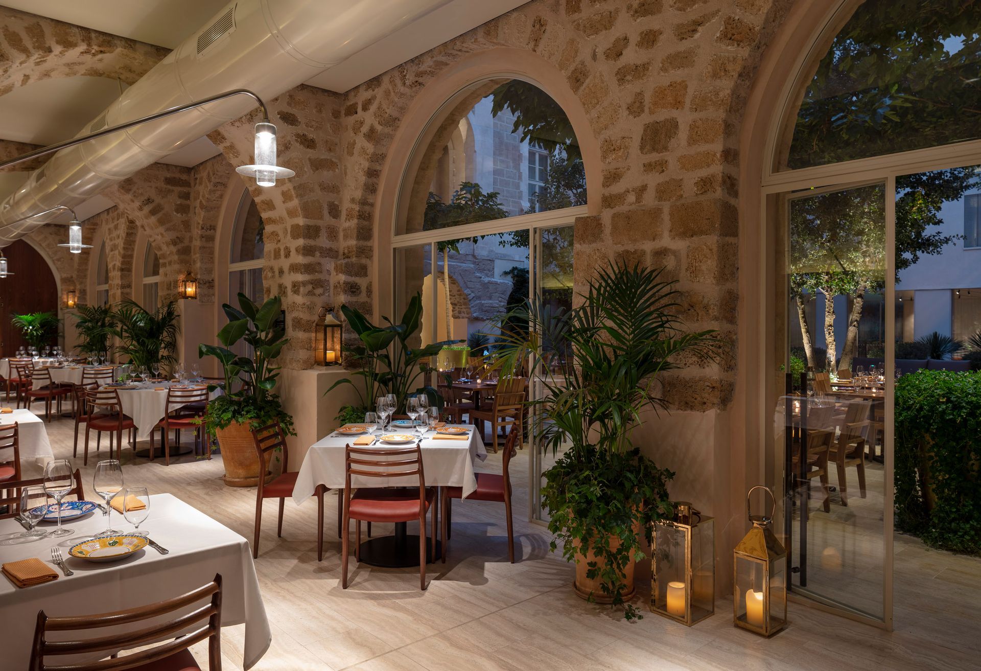 A restaurant with tables and chairs and a lot of windows