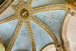 A dome with a dove in the center of it