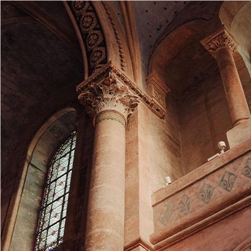 A church with columns and a stained glass window