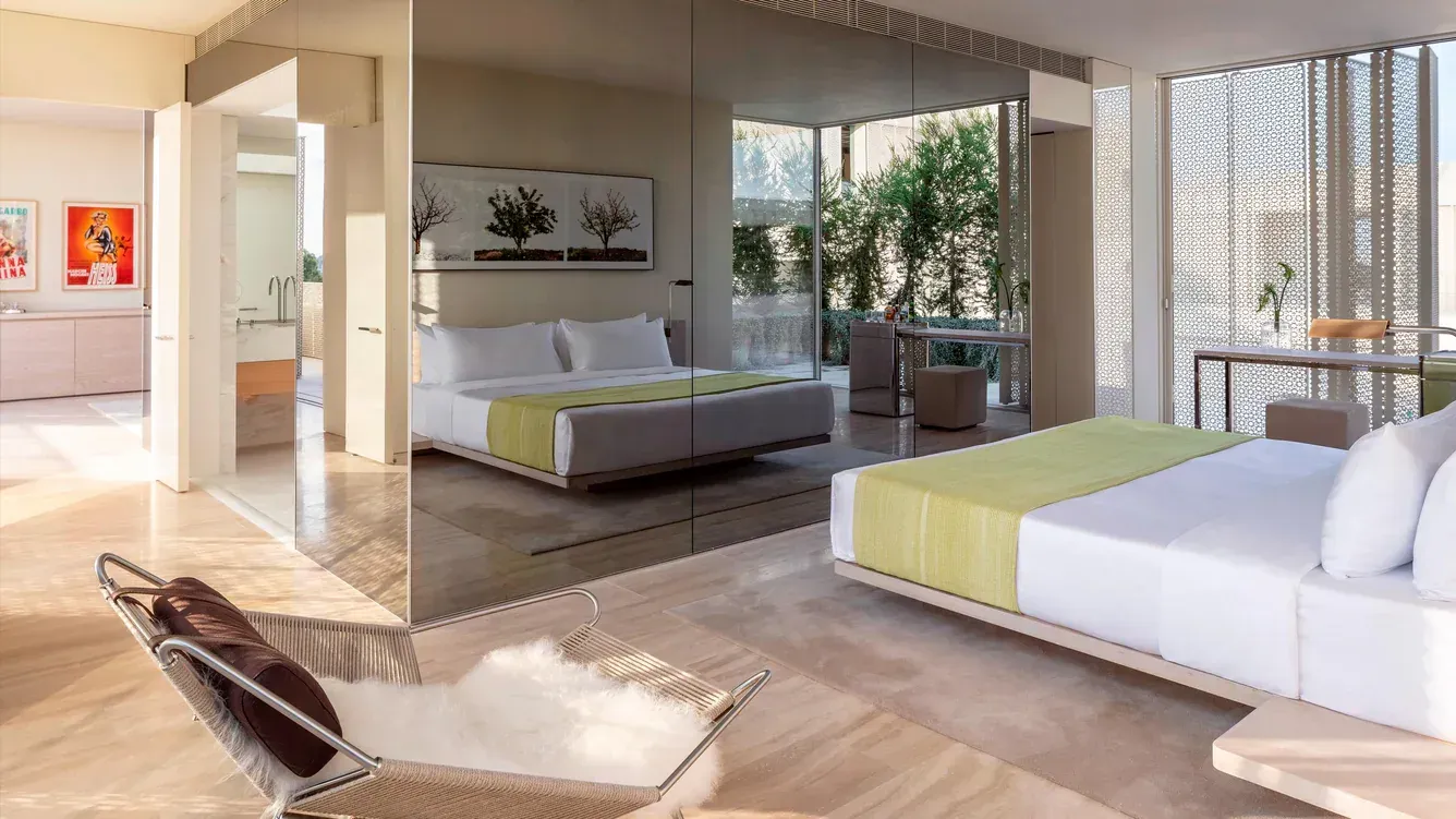 A bedroom with a large bed and a bathtub.