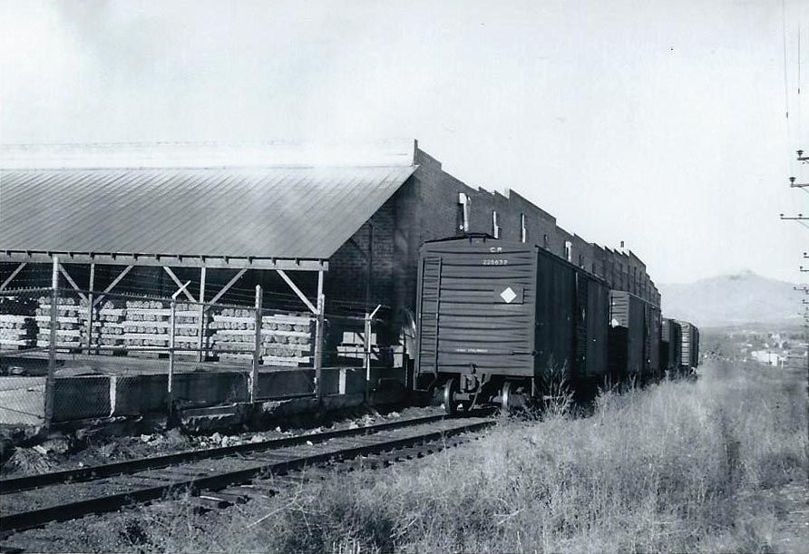 A black and white photo of a train on the tracks