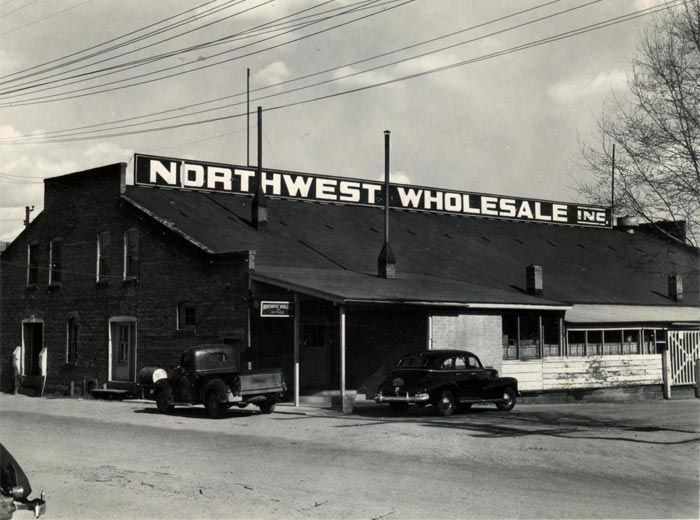 A black and white photo of a northwest wholesale store