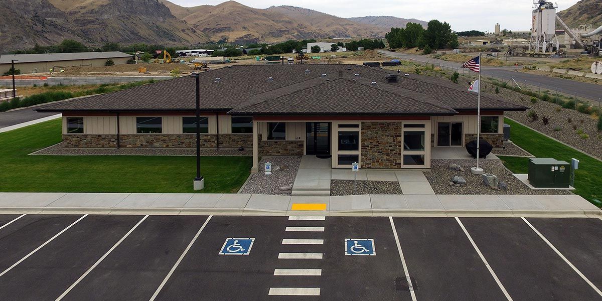 An aerial view of a building with a parking lot in front of it