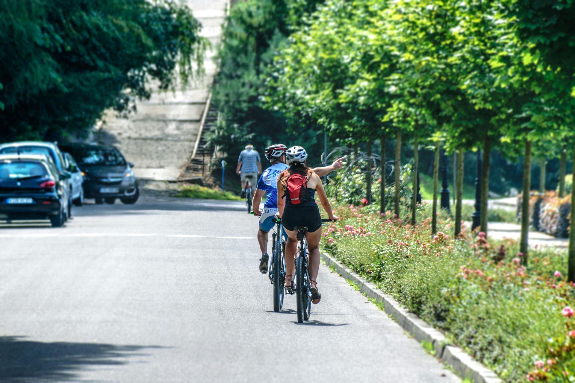 A group of people are riding bicycles down a street.