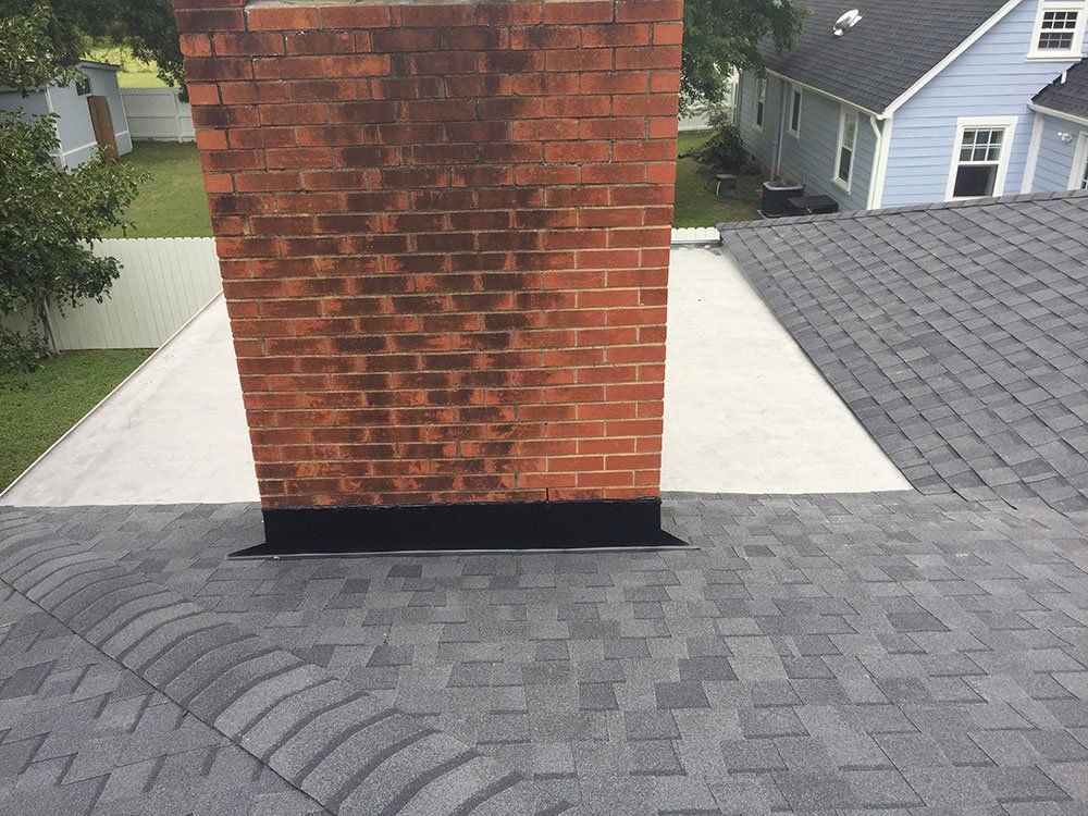 close up of chimney on roof from Shield Roofing