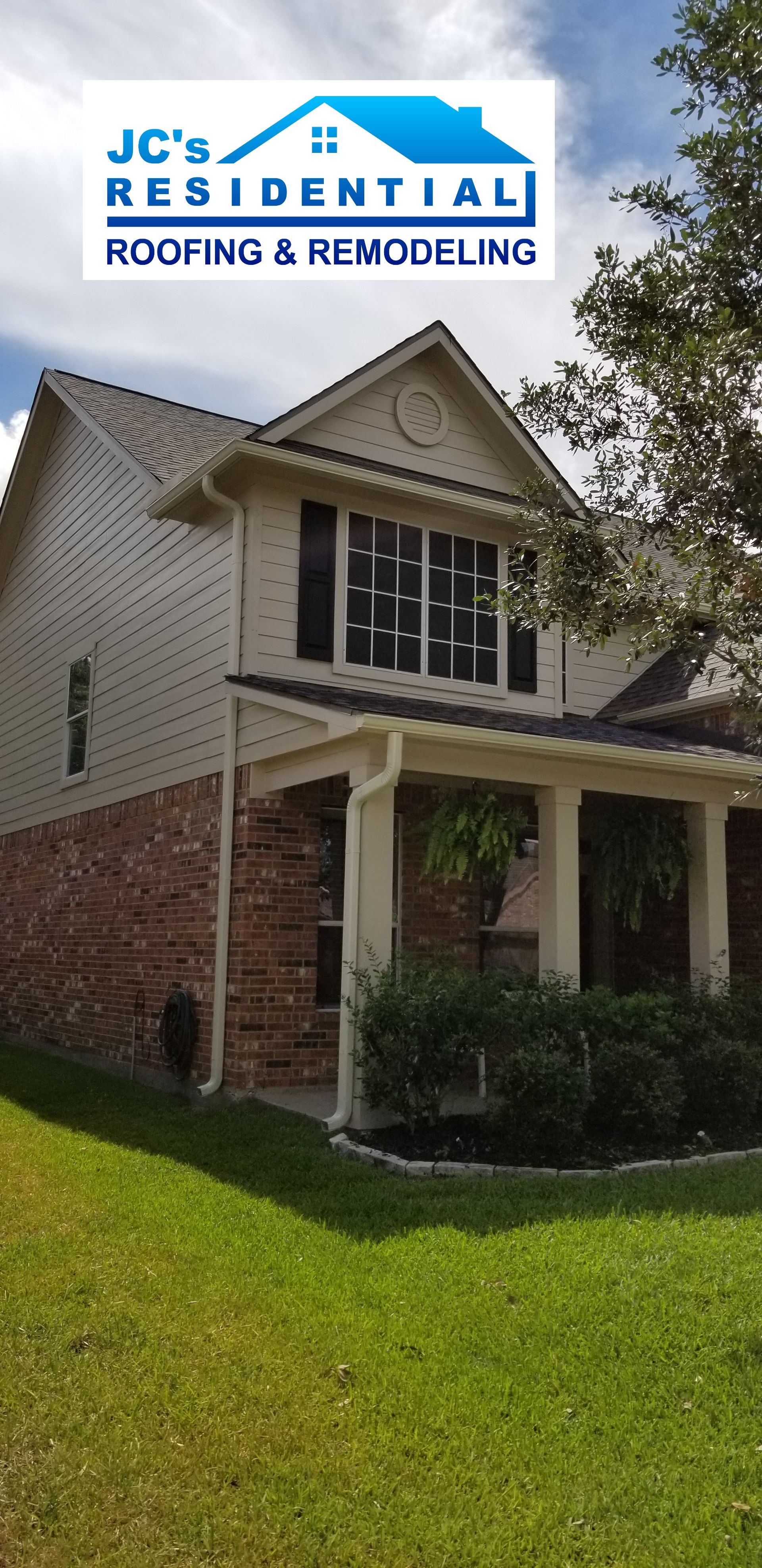 A two-story house with brick base and white siding, logo 