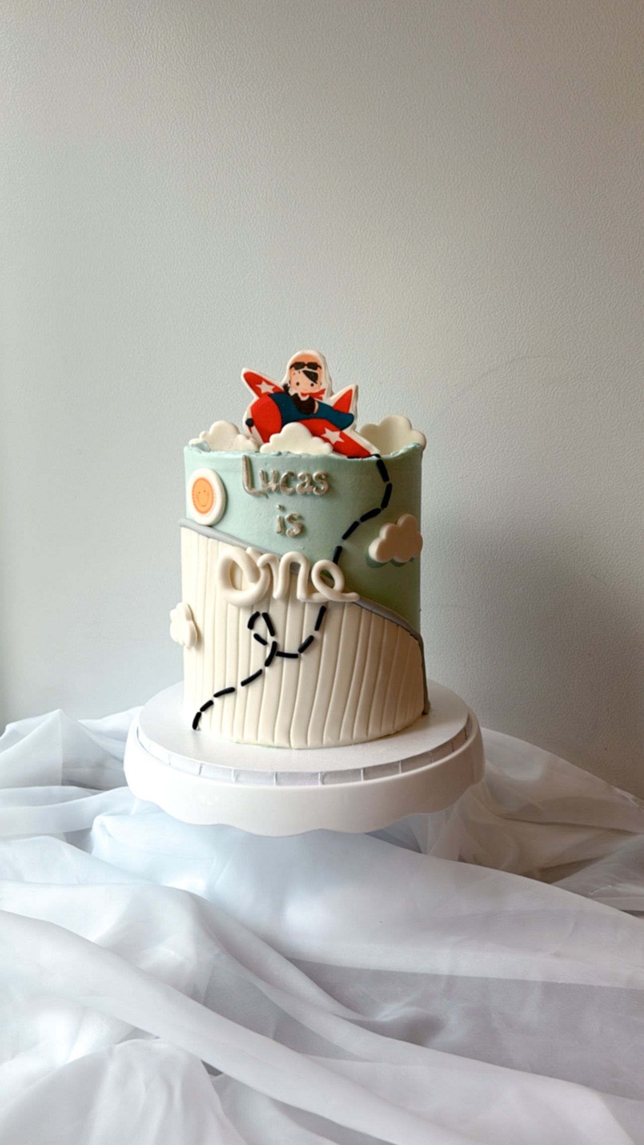 A cake with a plane on top of it is sitting on a table.