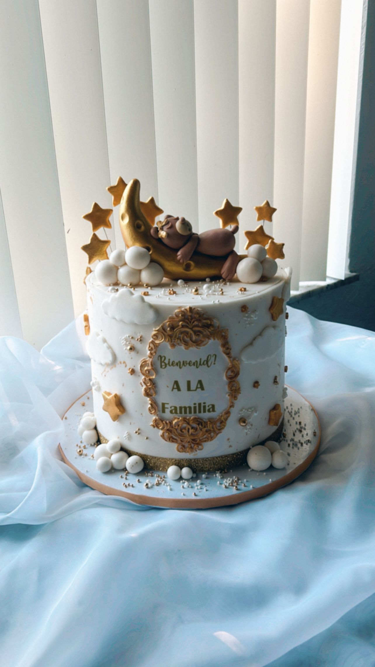 A cake with a baby sleeping on the moon and stars on it