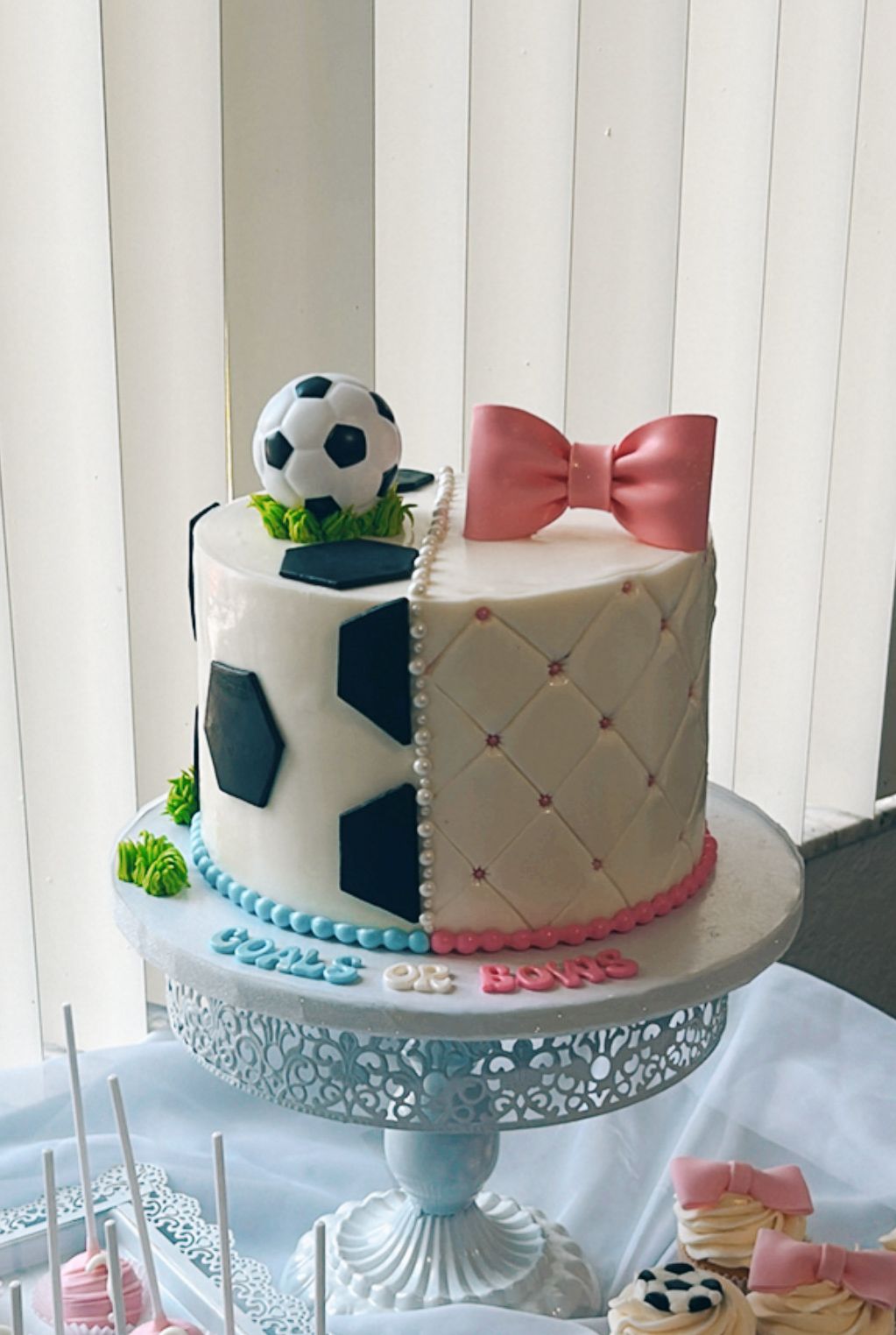 A cake with a soccer ball on top of it is on a table.