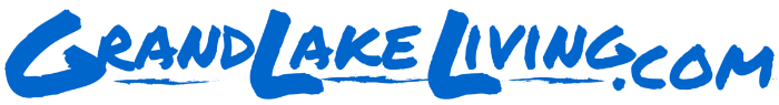 The logo for grand lake living.com is blue on a white background.