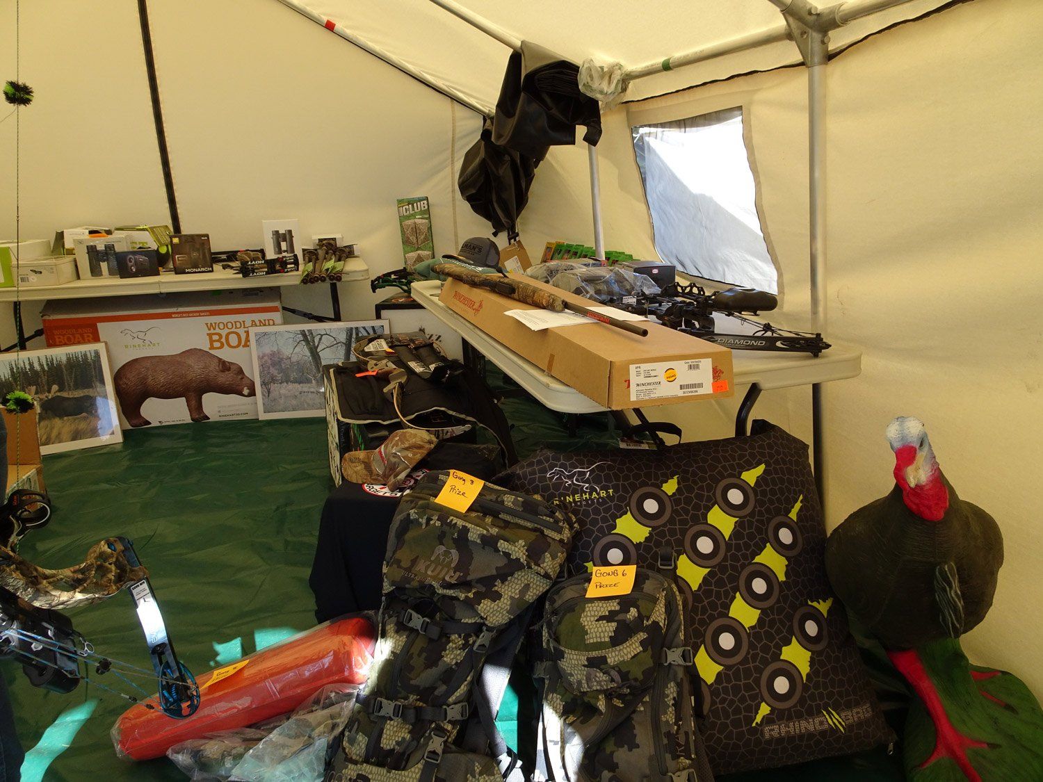 A tent filled with a lot of hunting equipment