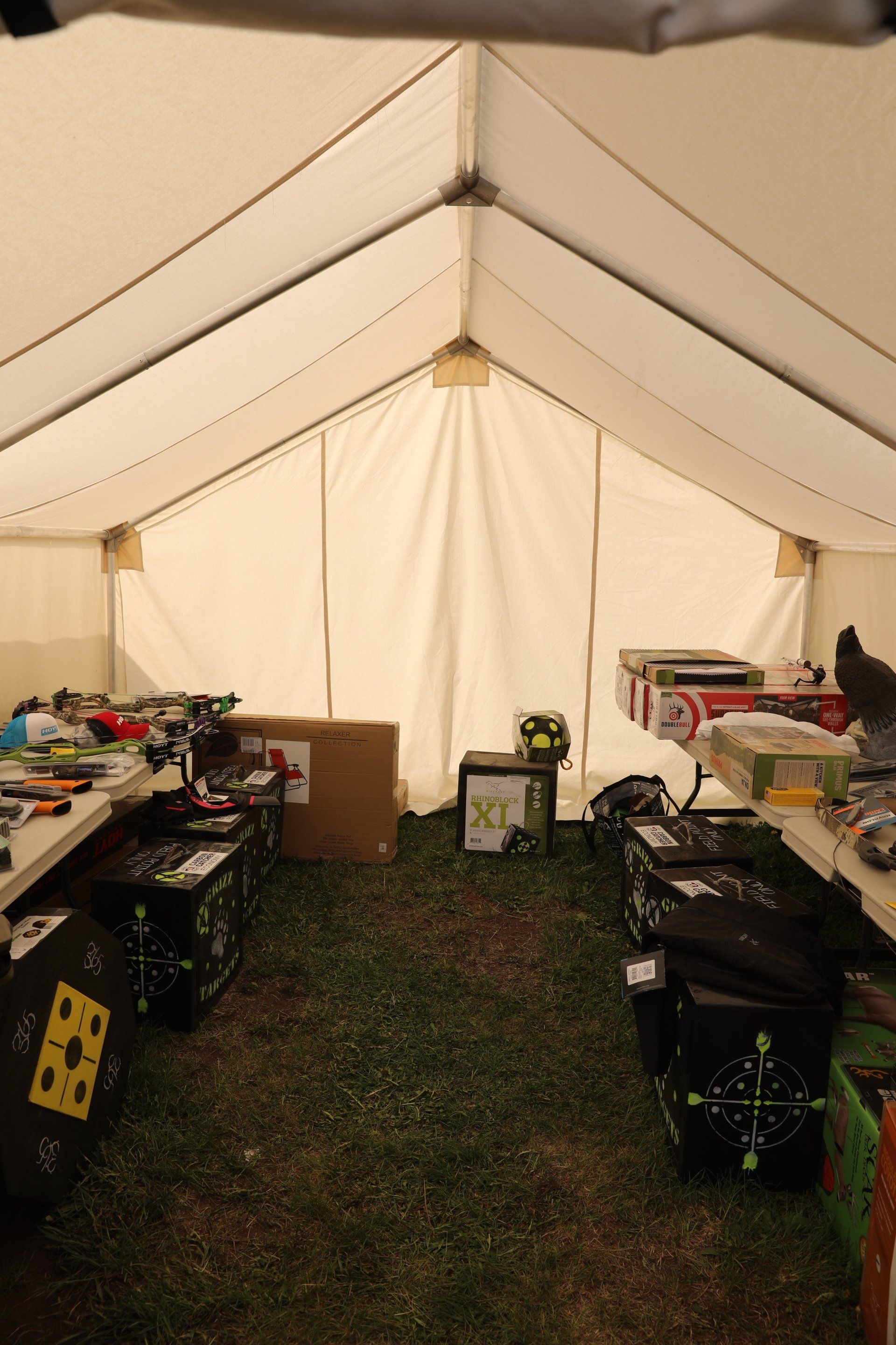 The inside of a tent filled with boxes and toys.
