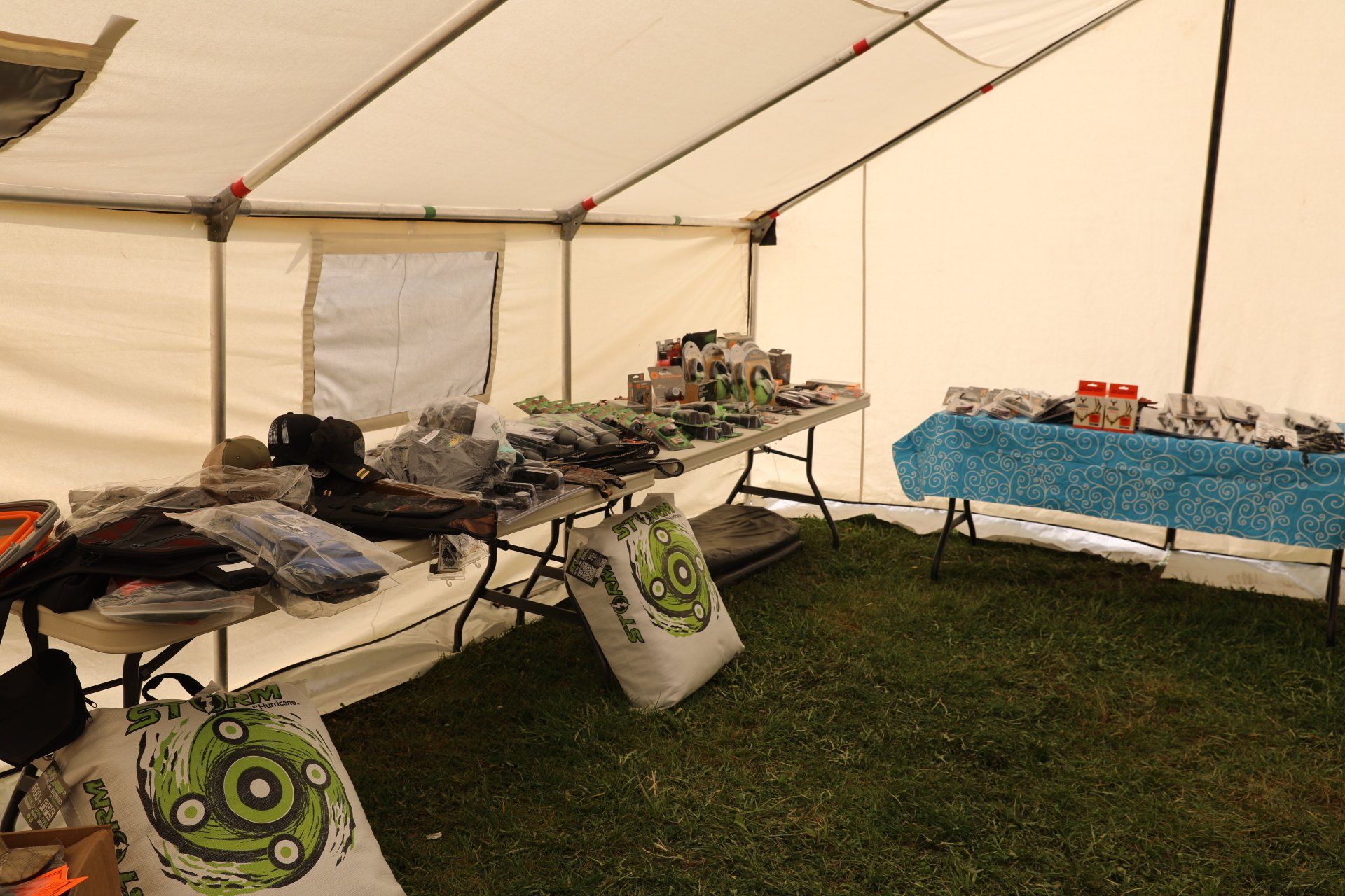 A tent filled with tables and bags of soil