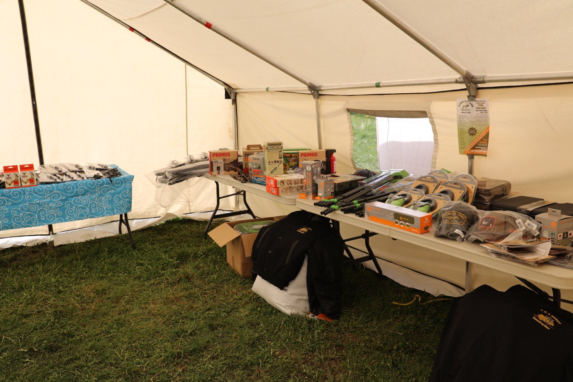 A tent with tables and boxes inside of it
