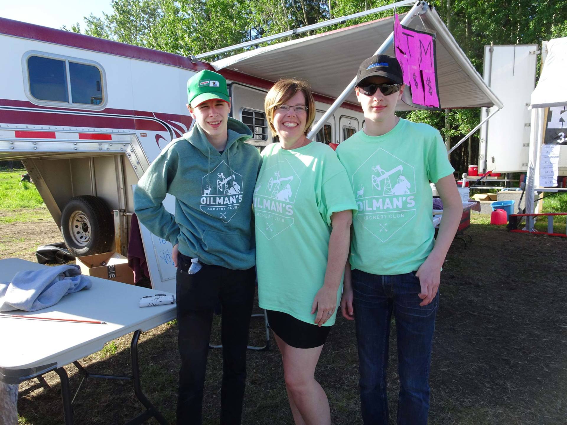 Three people wearing green shirts that say st. mary 's