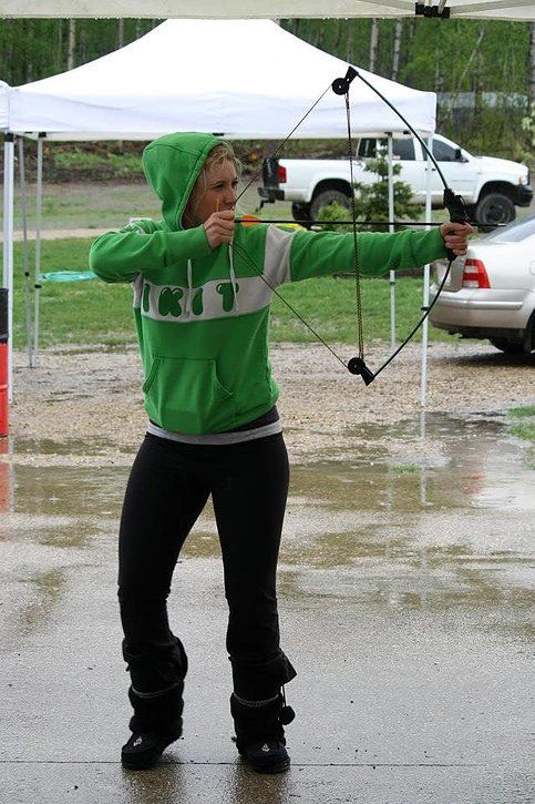 A woman in a green sweatshirt with the letter t on it