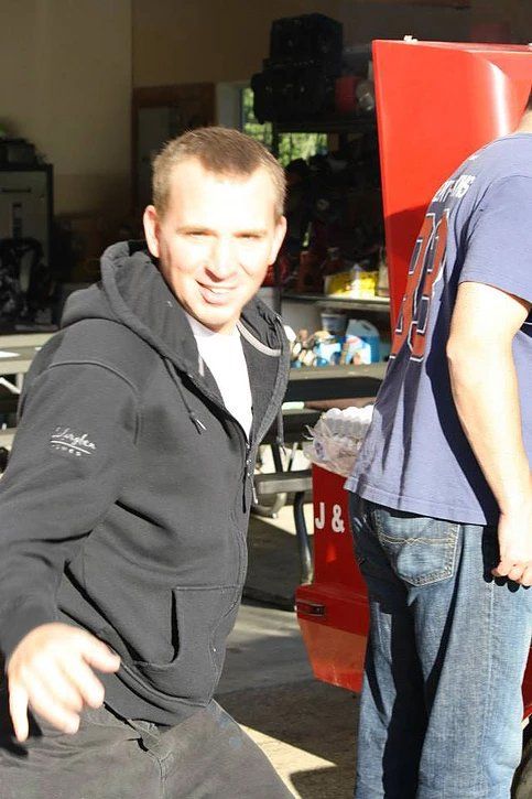 A man wearing a black hoodie with the letter n on it