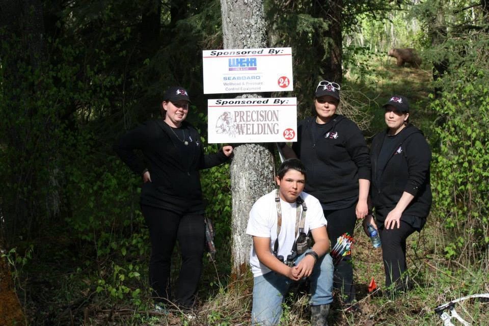 A group of people standing next to a sign that says precision snow loading