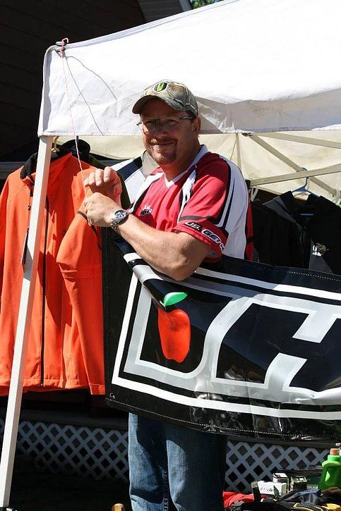 A man holding a sign that says dc on it