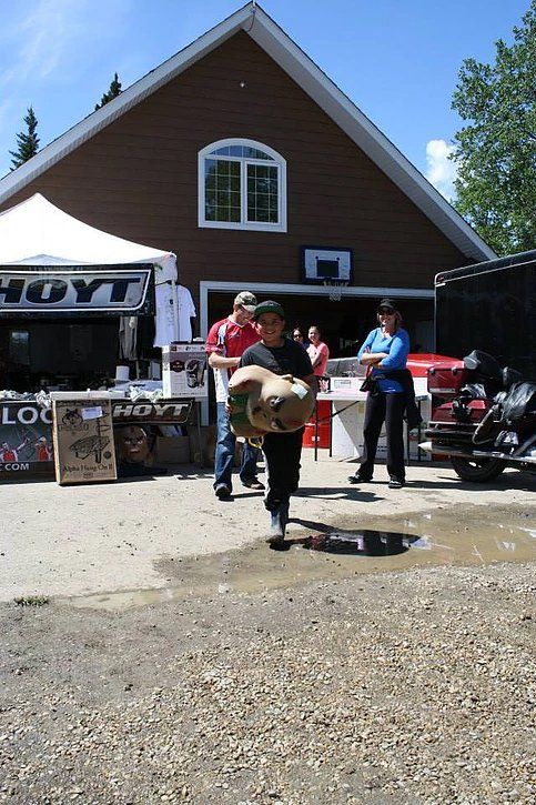 A boy is carrying a box in front of a hayt store