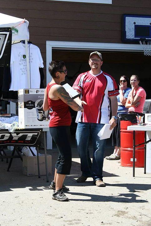 A man and a woman are shaking hands in front of a store.