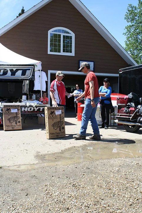 A man standing in front of a building that has the word kyt on it