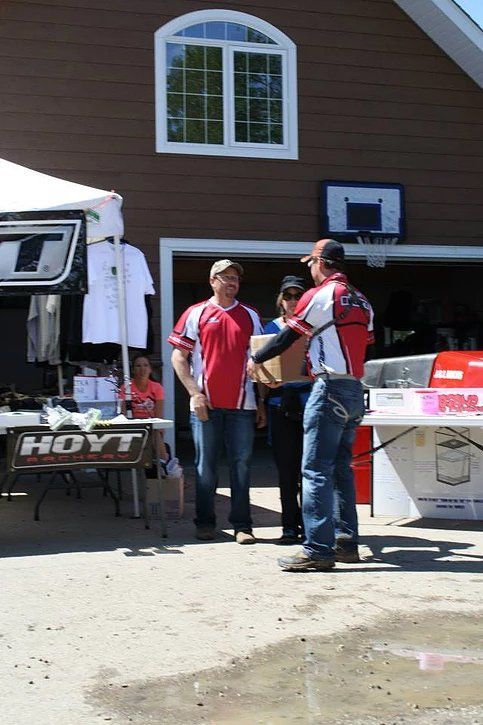 A group of men standing in front of a hayt sign
