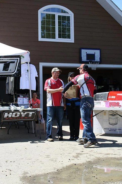 A group of people standing in front of a hayt table