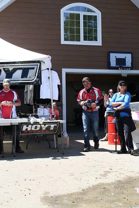 A group of people standing in front of a hayt sign