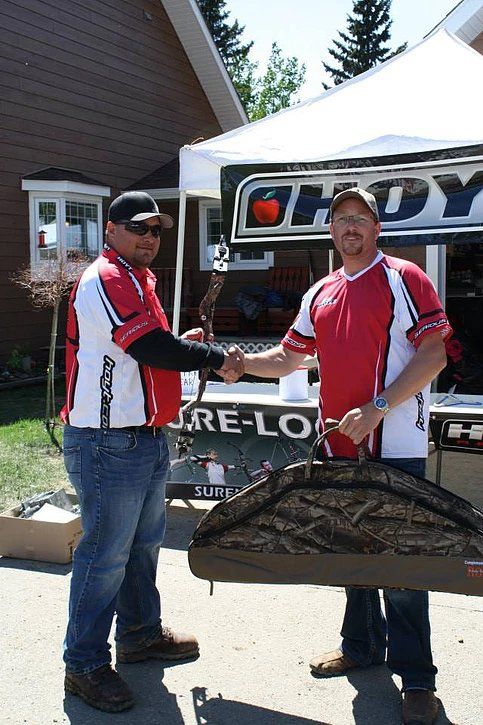 Two men shaking hands in front of a sign that says re-lo
