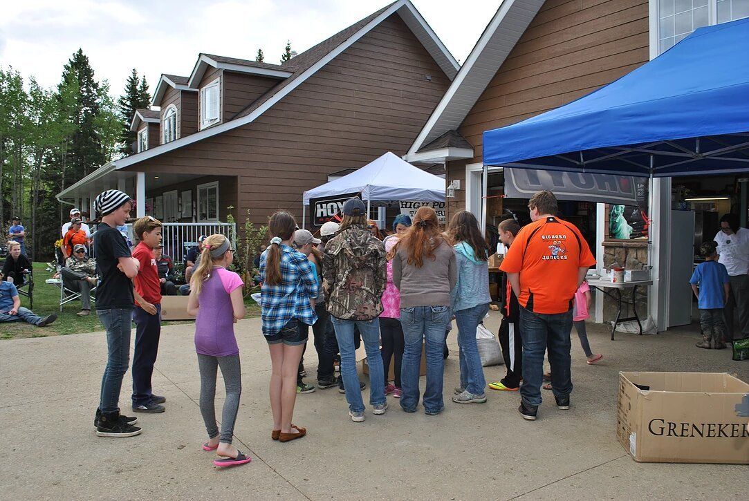 A group of people standing in front of a blue tent that says guinness