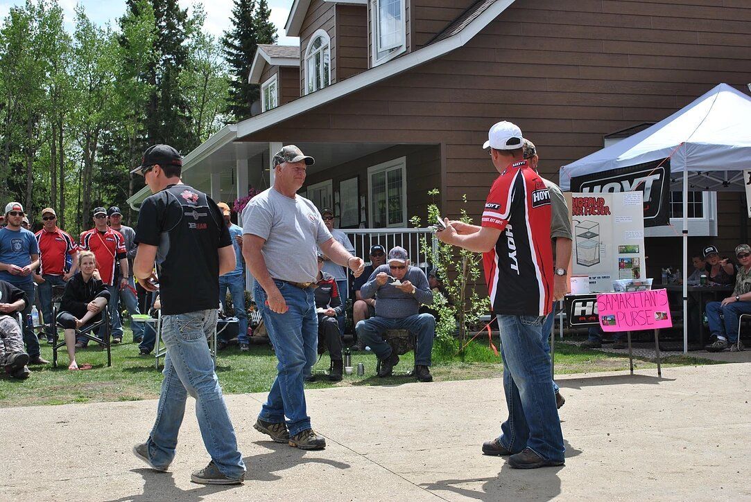 A group of men are standing in front of a house.