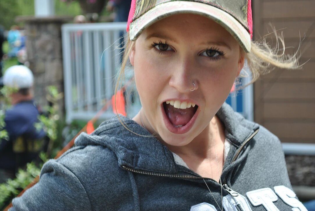 A woman wearing a hat and a sweatshirt with the word jets on it