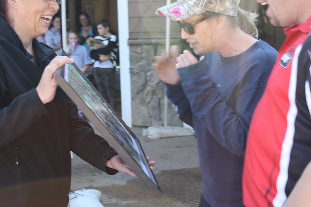 A man wearing a crown and sunglasses is talking to a woman
