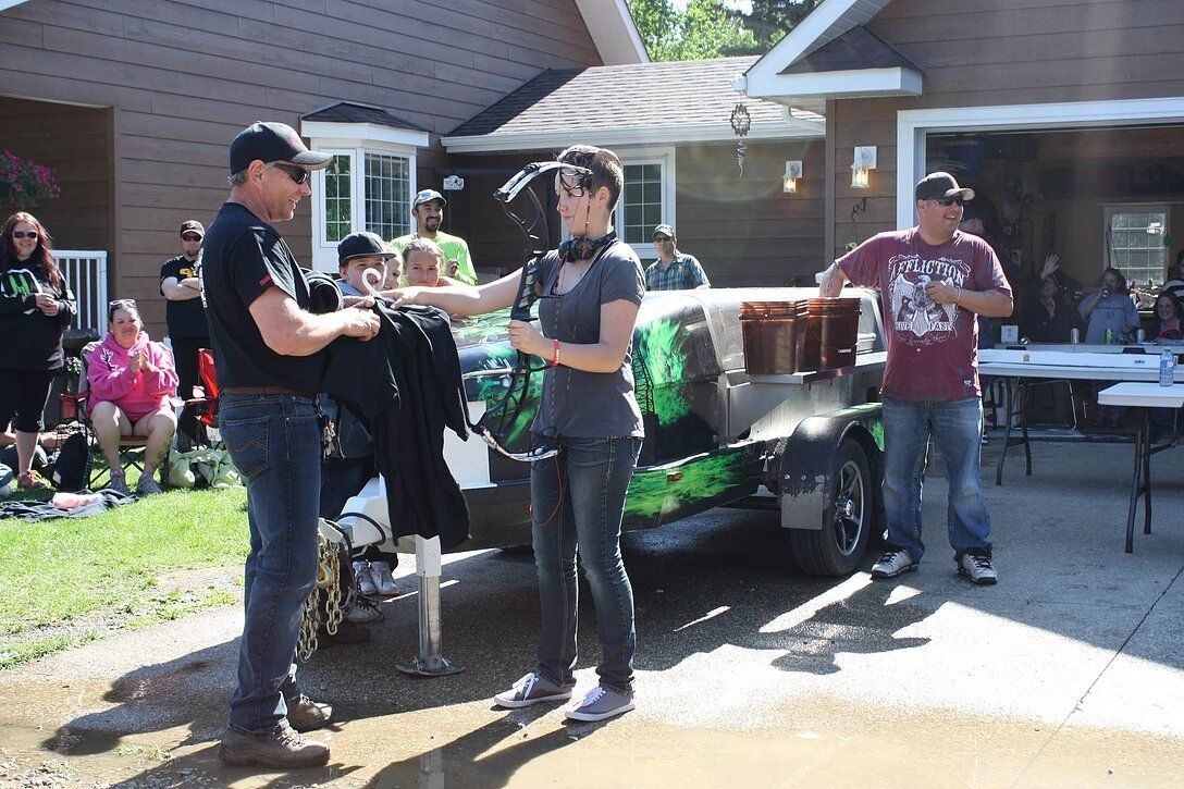 A group of people are standing in front of a house.
