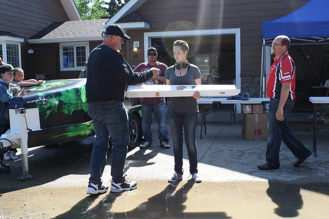 A man is giving a woman a piece of wood