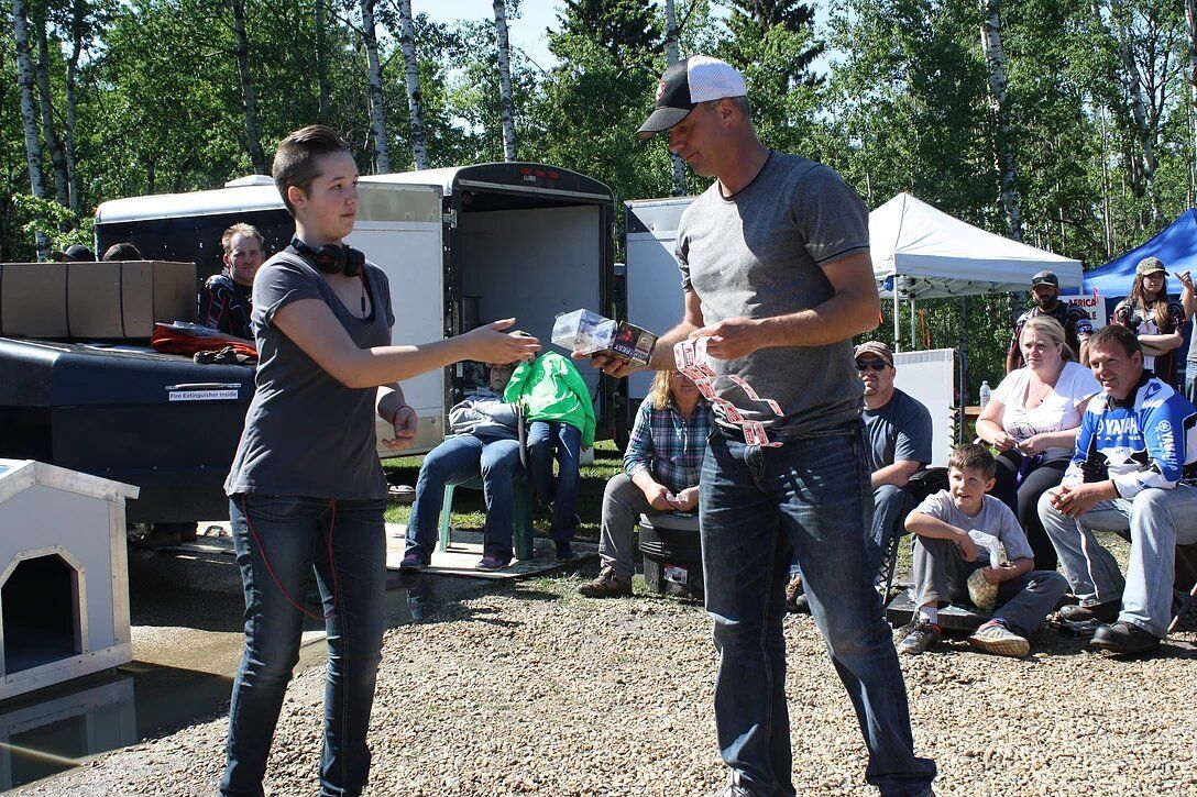 A man and a woman are standing next to each other in front of a crowd.