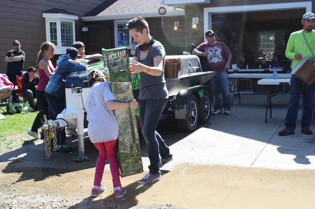 A group of people are standing in front of a house.