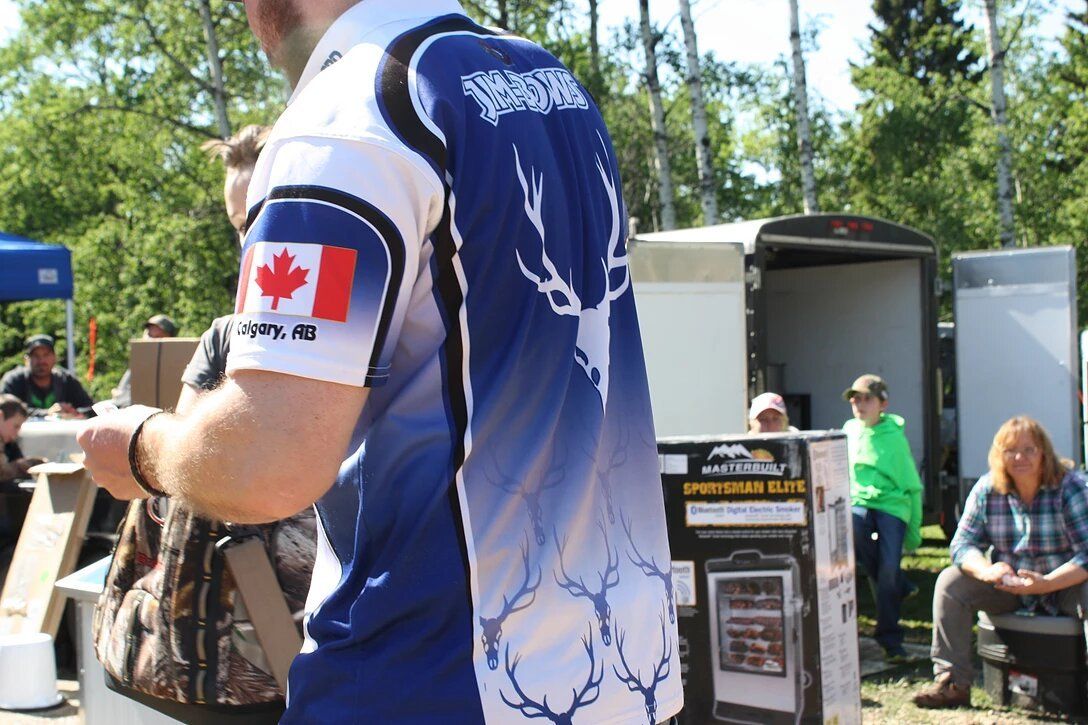 A man wearing a blue shirt with a canadian flag on his sleeve