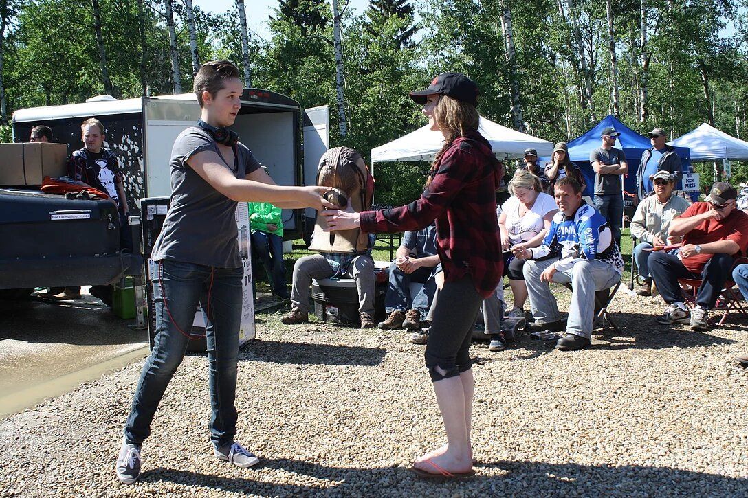Two people are dancing in front of a crowd of people.