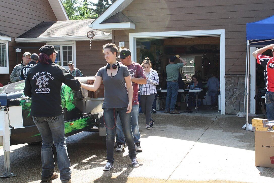 A group of people are standing in front of a house