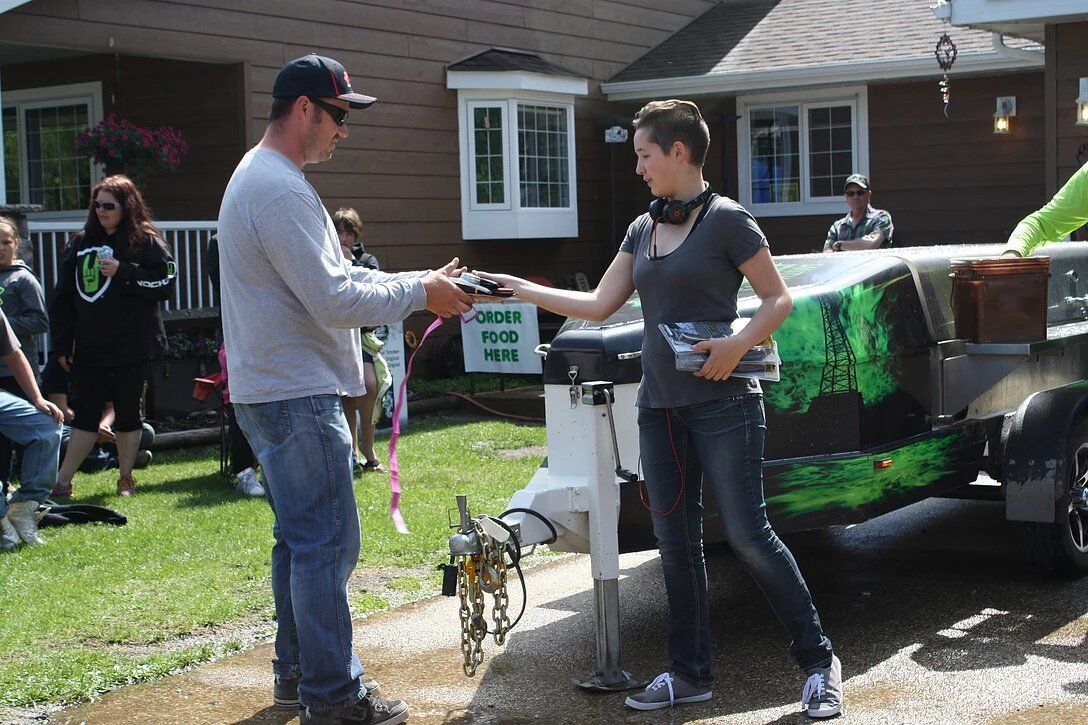A man and a woman are standing in front of a trailer