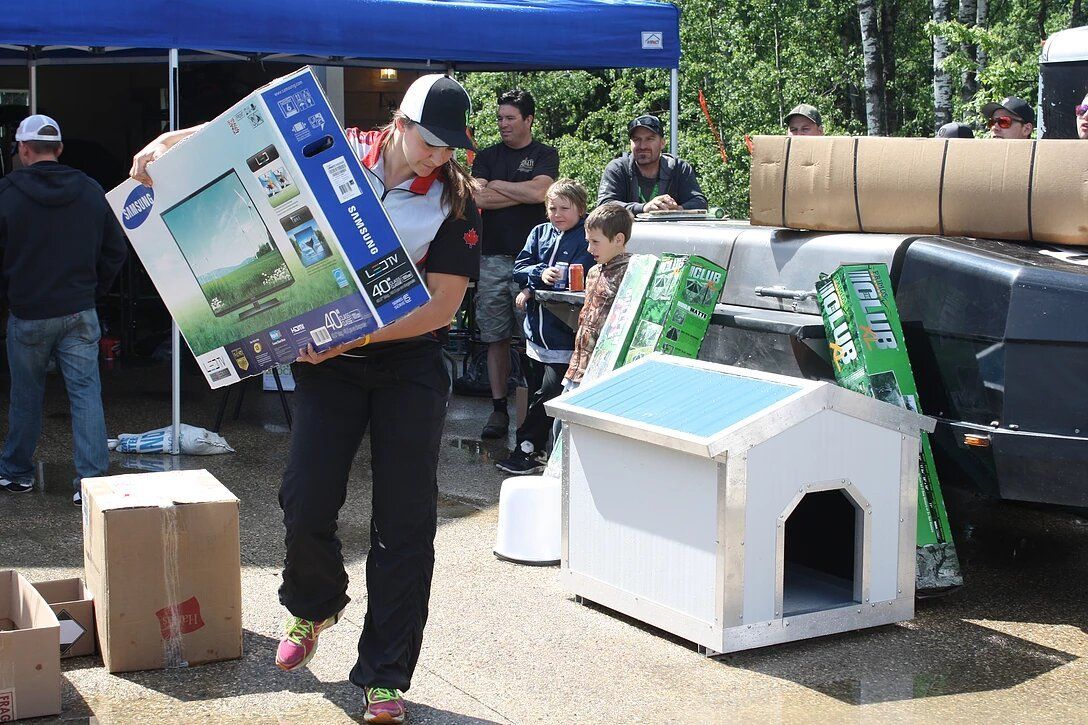 A man is carrying a box that says samsung on it.
