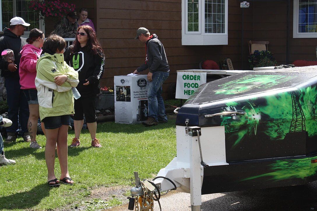 A group of people standing in front of a house with a sign that says order food here