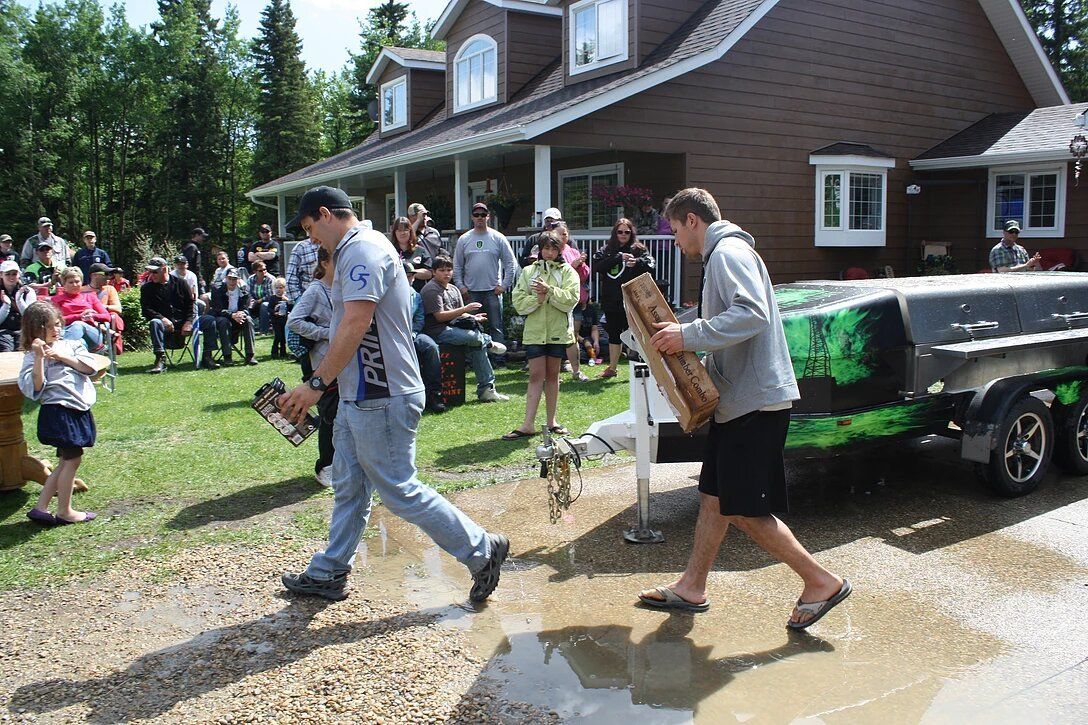 A group of people are standing in front of a house.