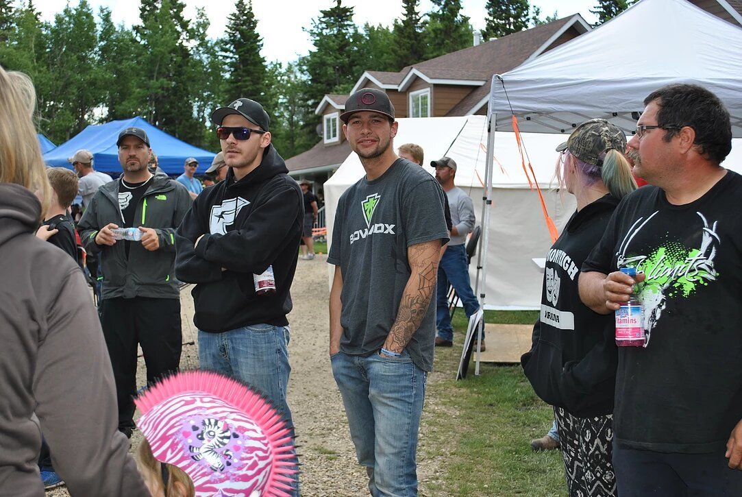 A group of people are standing in front of a tent.