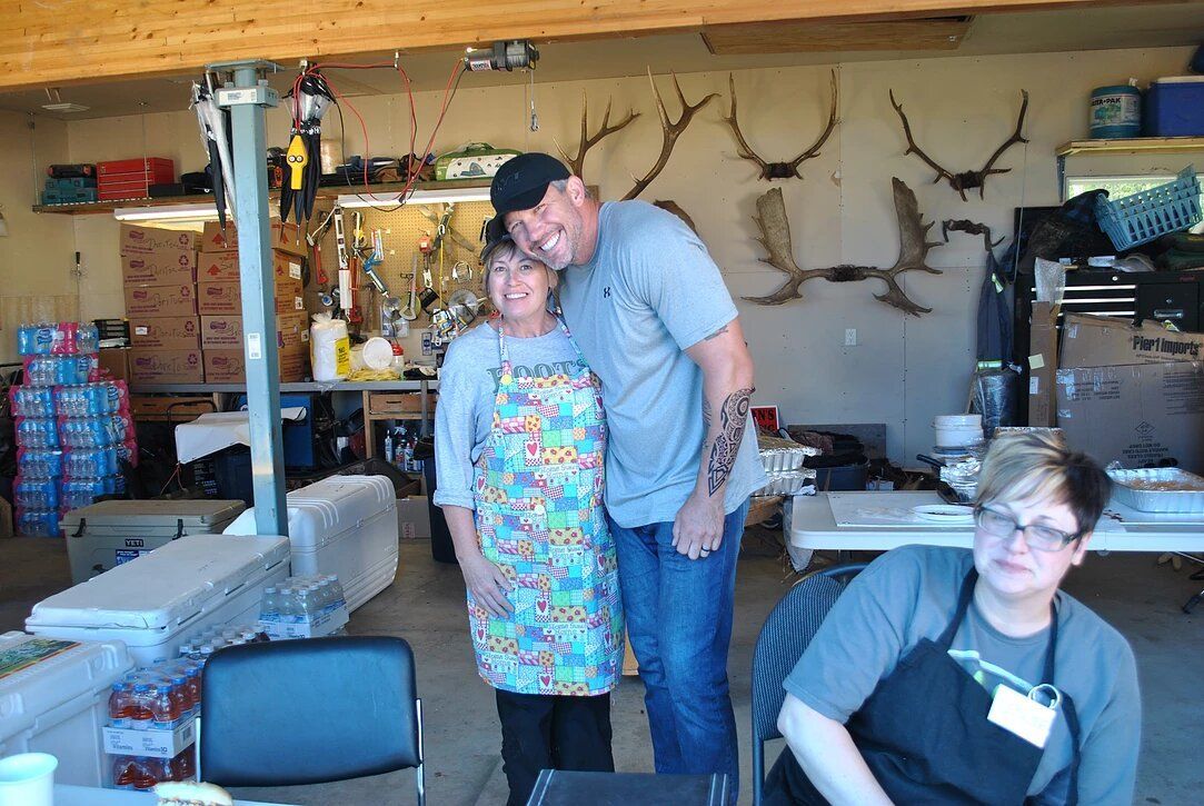 A man and a woman are standing next to each other in a room.