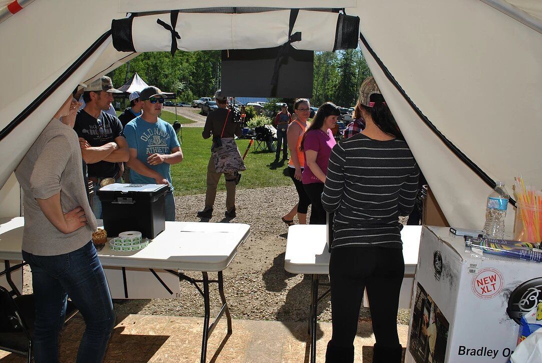 A group of people are standing around a table that says branley on it