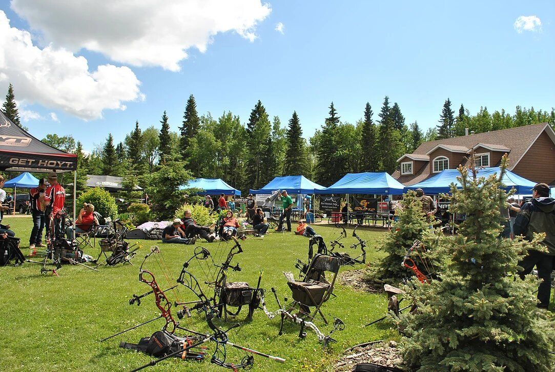 A group of people are gathered in a grassy field.
