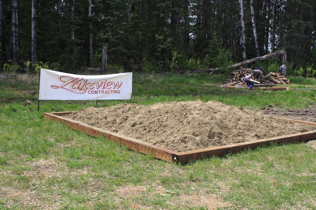 A sandbox with a sign in the middle of it.